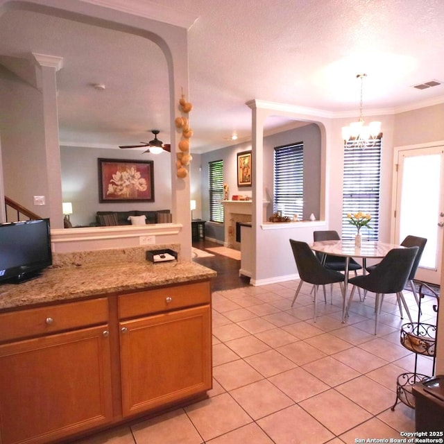 12115 Redbud Leaf, San Antonio, TX 78253 - kitchen featuring light tile patterned flooring, ornamental molding, a chandelier, hanging light fixtures, and open floor plan