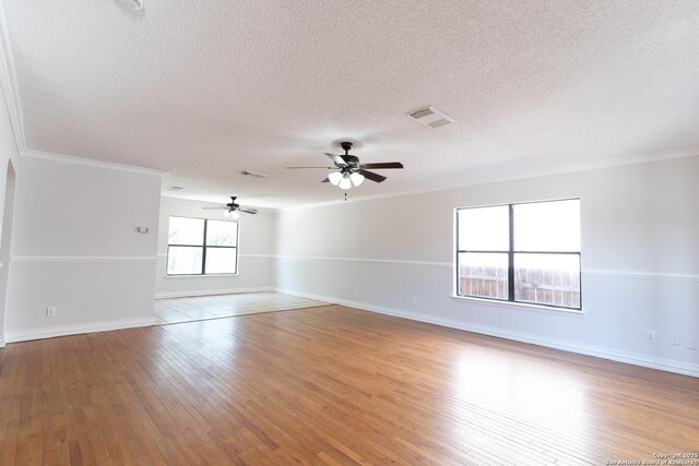 10322 Fork Crk, San Antonio, TX 78245 - empty room featuring ceiling fan, a textured ceiling, crown molding, hardwood / wood-style floors, and baseboards