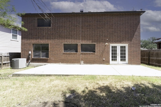 10322 Fork Crk, San Antonio, TX 78245 - back of house with french doors, cooling unit, brick siding, and a patio area