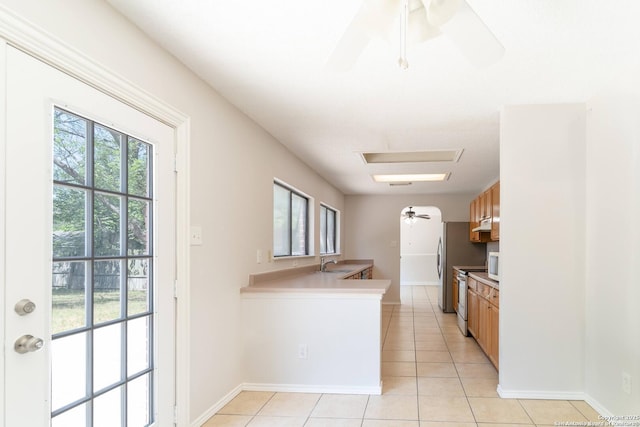 10322 Fork Crk, San Antonio, TX 78245 - kitchen featuring a sink, light tile patterned floors, a ceiling fan, and light countertops