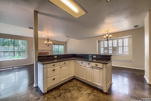 1510 Kingsbridge, San Antonio, TX 78253 - kitchen featuring a chandelier, dark countertops, a textured ceiling, concrete flooring, and baseboards