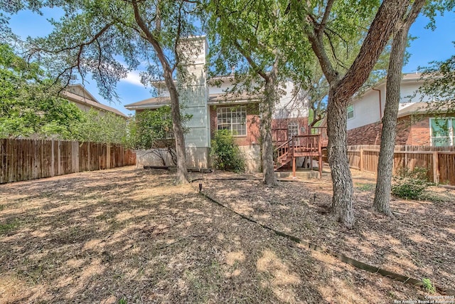1510 Kingsbridge, San Antonio, TX 78253 - rear view of property with a fenced backyard, stairway, and brick siding