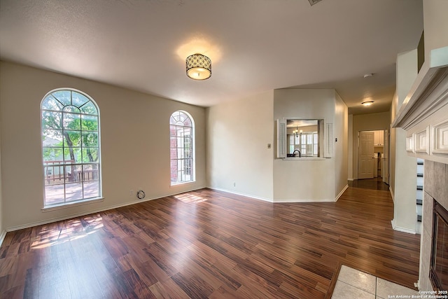 1510 Kingsbridge, San Antonio, TX 78253 - empty room featuring wood finished floors, a tile fireplace, and baseboards