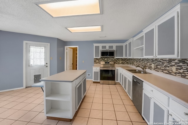 9503 Marshall Pt, San Antonio, TX 78240 - kitchen with appliances with stainless steel finishes, open shelves, a sink, light tile patterned flooring, and tasteful backsplash