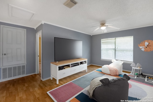 9503 Marshall Pt, San Antonio, TX 78240 - living room with wood finished floors, ceiling fan, crown molding, attic access, and baseboards