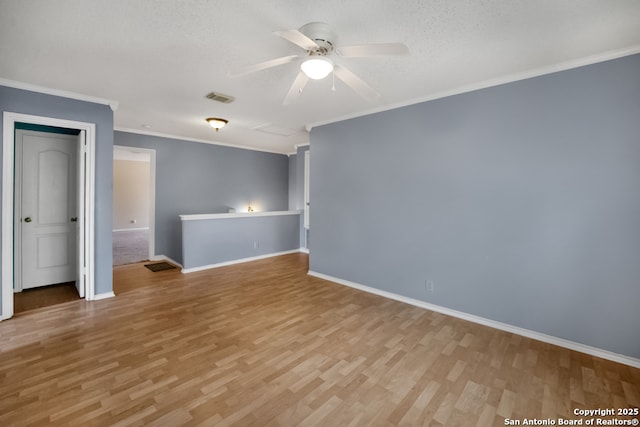 9503 Marshall Pt, San Antonio, TX 78240 - unfurnished room with light wood-style flooring, ornamental molding, baseboards, ceiling fan, and a textured ceiling