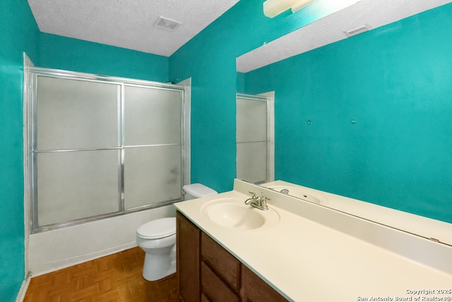 9503 Marshall Pt, San Antonio, TX 78240 - bathroom with toilet, vanity, a textured ceiling, and enclosed tub / shower combo
