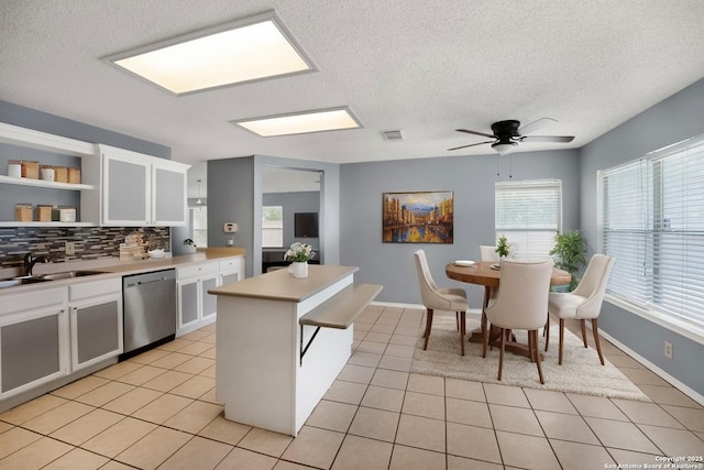9503 Marshall Pt, San Antonio, TX 78240 - kitchen featuring dishwasher, open shelves, light tile patterned floors, a sink, and white cabinets