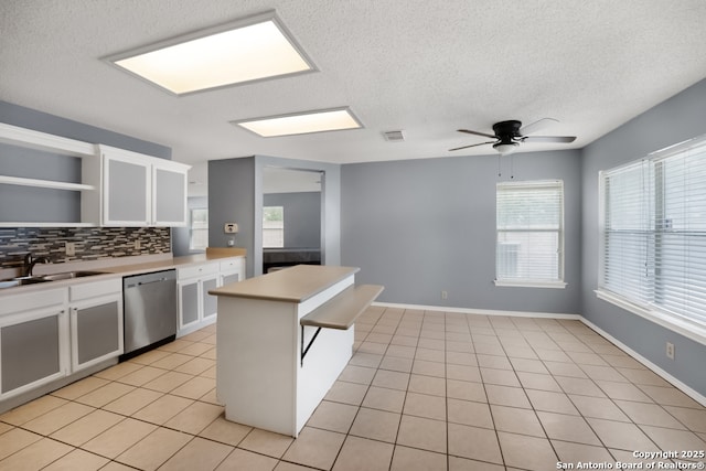 9503 Marshall Pt, San Antonio, TX 78240 - kitchen featuring stainless steel dishwasher, open shelves, a sink, decorative backsplash, and white cabinetry