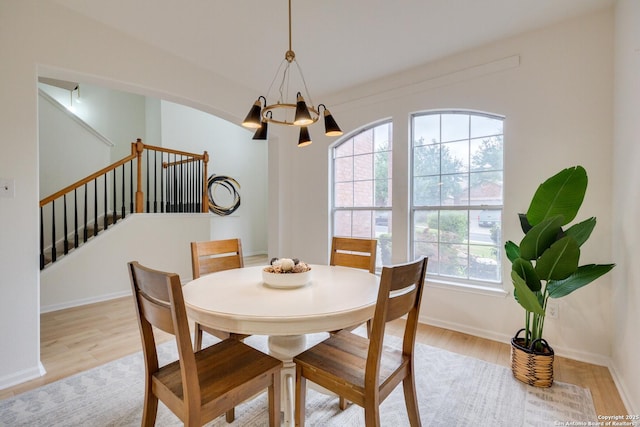 12031 Wellstone, San Antonio, TX 78249 - dining area with stairs, light wood-style floors, a chandelier, and baseboards