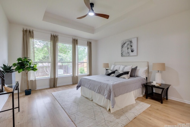 12031 Wellstone, San Antonio, TX 78249 - bedroom with a raised ceiling, light wood-style floors, crown molding, baseboards, and ceiling fan