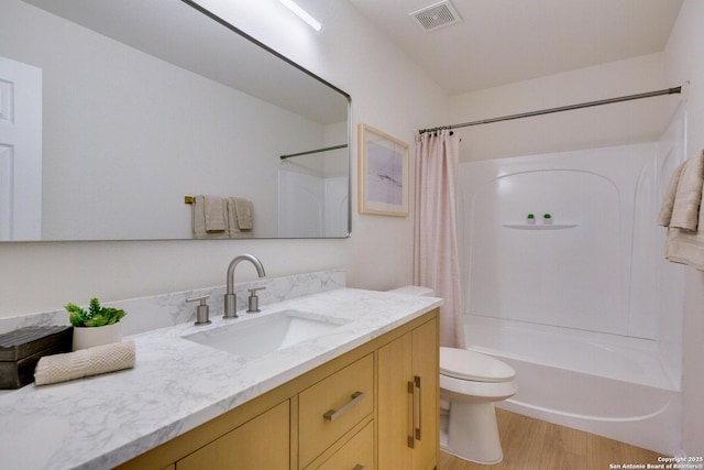 12031 Wellstone, San Antonio, TX 78249 - bathroom with toilet, vanity, wood finished floors, and shower / bath combo