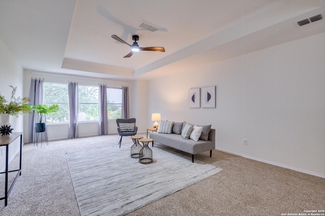 12031 Wellstone, San Antonio, TX 78249 - living room featuring carpet floors, a ceiling fan, a raised ceiling, and baseboards