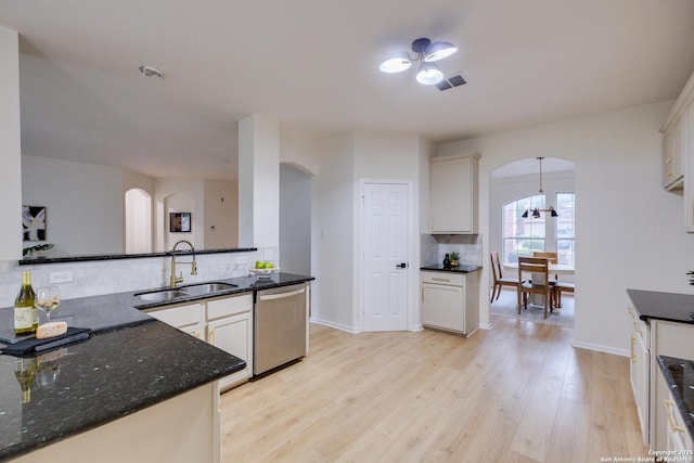 12031 Wellstone, San Antonio, TX 78249 - kitchen with dishwasher, arched walkways, a sink, and backsplash