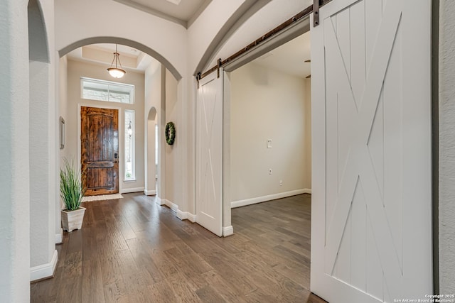 2714 Trailmont Dr, San Antonio, TX 78253 - entryway with a barn door, arched walkways, dark wood-type flooring, and baseboards