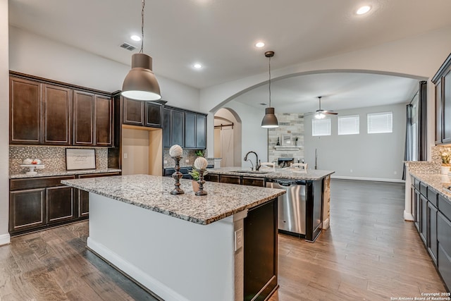 2714 Trailmont Dr, San Antonio, TX 78253 - kitchen featuring a ceiling fan, arched walkways, stainless steel dishwasher, decorative backsplash, and a sink