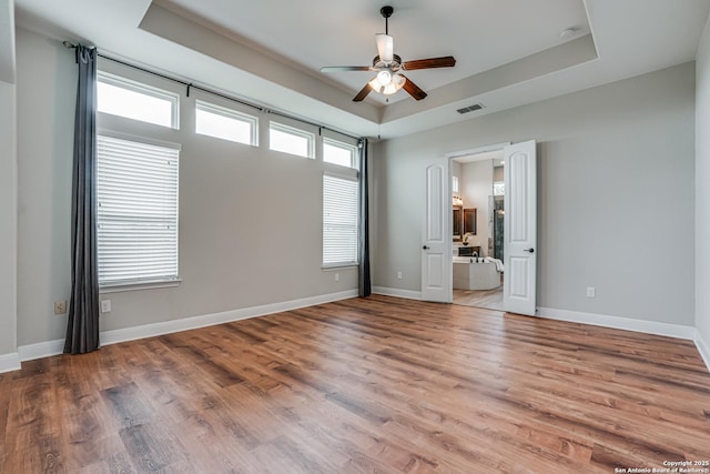 2714 Trailmont Dr, San Antonio, TX 78253 - unfurnished room featuring a tray ceiling, ceiling fan, wood finished floors, and baseboards