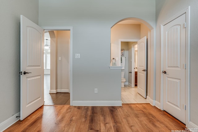 2714 Trailmont Dr, San Antonio, TX 78253 - unfurnished bedroom with light wood-style flooring, arched walkways, connected bathroom, and baseboards