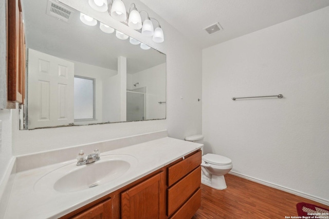 5815 Trent, San Antonio, TX 78249 - bathroom with vanity, a shower, toilet, wood finished floors, and baseboards
