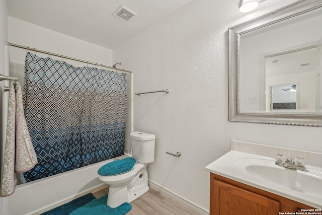 5815 Trent, San Antonio, TX 78249 - bathroom featuring toilet, vanity, shower / tub combo with curtain, wood finished floors, and baseboards