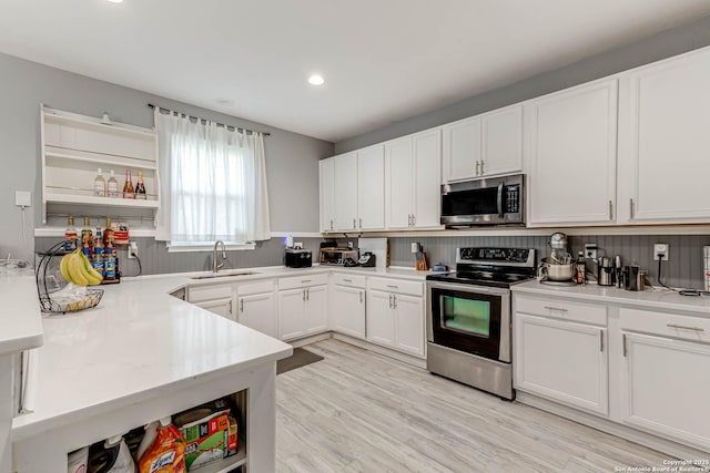 20827 Foothill Pne, San Antonio, TX 78259 - kitchen featuring stainless steel appliances, open shelves, a sink, light countertops, and white cabinetry