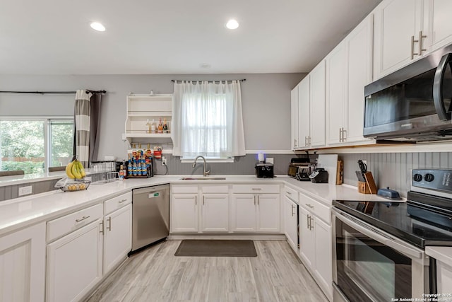 20827 Foothill Pne, San Antonio, TX 78259 - kitchen with appliances with stainless steel finishes, a sink, white cabinets, recessed lighting, and light countertops