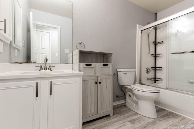 20827 Foothill Pne, San Antonio, TX 78259 - bathroom featuring toilet, vanity, enclosed tub / shower combo, and wood finished floors