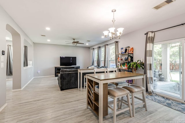 20827 Foothill Pne, San Antonio, TX 78259 - dining room with light wood-style flooring, a chandelier, arched walkways, recessed lighting, and baseboards