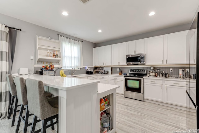 20827 Foothill Pne, San Antonio, TX 78259 - kitchen featuring stainless steel appliances, a sink, open shelves, light countertops, and recessed lighting