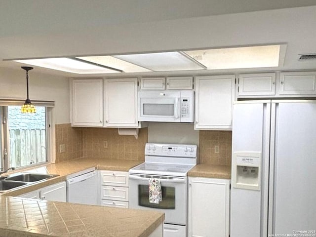8526 Timberwilde, San Antonio, TX 78250 - kitchen with white appliances, a sink, hanging light fixtures, and backsplash