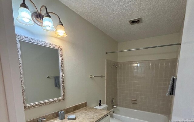 8526 Timberwilde, San Antonio, TX 78250 - full bathroom featuring a textured ceiling, shower / bathtub combination, toilet, and vanity