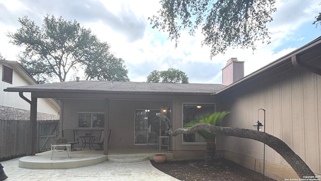 8526 Timberwilde, San Antonio, TX 78250 - rear view of property with a chimney and a patio area