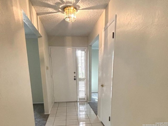 8526 Timberwilde, San Antonio, TX 78250 - entryway with light tile patterned flooring, a textured ceiling, and baseboards