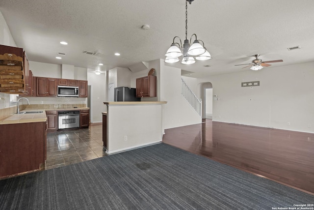 4635 Branching Bay, San Antonio, TX 78259 - kitchen featuring appliances with stainless steel finishes, a sink, a textured ceiling, a ceiling fan, and light countertops