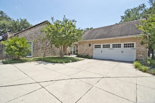8 Kensington Ct, San Antonio, TX 78218 - view of front of home featuring brick siding, a garage, a tile roof, and concrete driveway