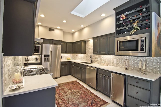 8 Kensington Ct, San Antonio, TX 78218 - kitchen featuring stainless steel appliances, a sink, tasteful backsplash, light tile patterned floors, and recessed lighting