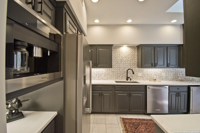 8 Kensington Ct, San Antonio, TX 78218 - kitchen with appliances with stainless steel finishes, a sink, light marble finish flooring, tasteful backsplash, and recessed lighting