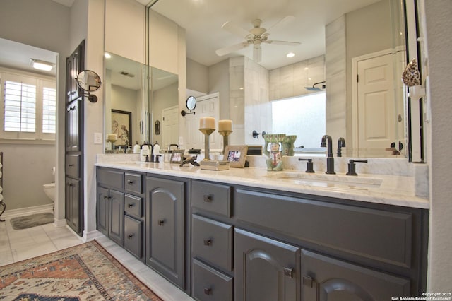 8 Kensington Ct, San Antonio, TX 78218 - bathroom with a ceiling fan, double vanity, toilet, tiled shower, and baseboards