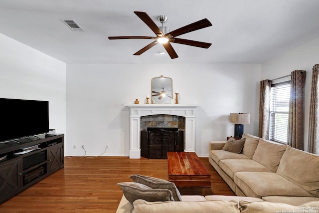 4451 Taylors Bnd, San Antonio, TX 78247 - living room with a ceiling fan, a tile fireplace, and wood finished floors