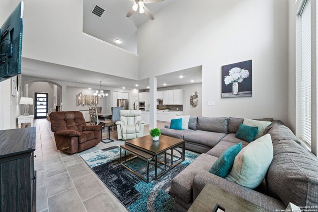 9706 Kremmen, Boerne, TX 78006 - living room with arched walkways, ceiling fan, a chandelier, a high ceiling, and recessed lighting