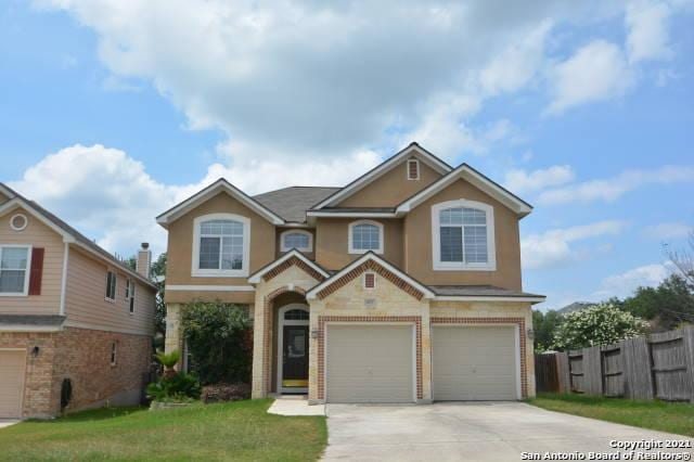 807 Maltese Gdn, San Antonio, TX 78260 - view of front facade with a garage, driveway, brick siding, and stucco siding