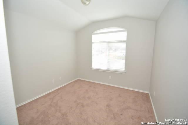 807 Maltese Gdn, San Antonio, TX 78260 - spare room with carpet flooring, lofted ceiling, and baseboards