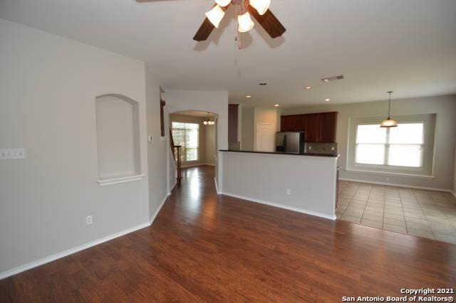 807 Maltese Gdn, San Antonio, TX 78260 - unfurnished living room featuring wood finished floors, baseboards, a ceiling fan, arched walkways, and recessed lighting