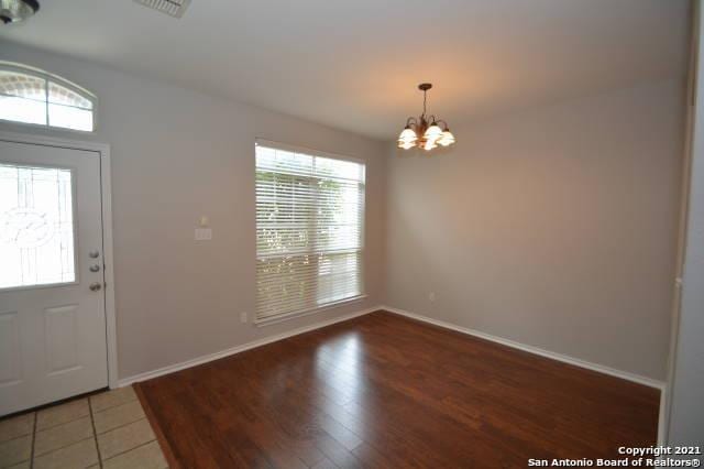 807 Maltese Gdn, San Antonio, TX 78260 - entrance foyer featuring a chandelier, baseboards, and wood finished floors