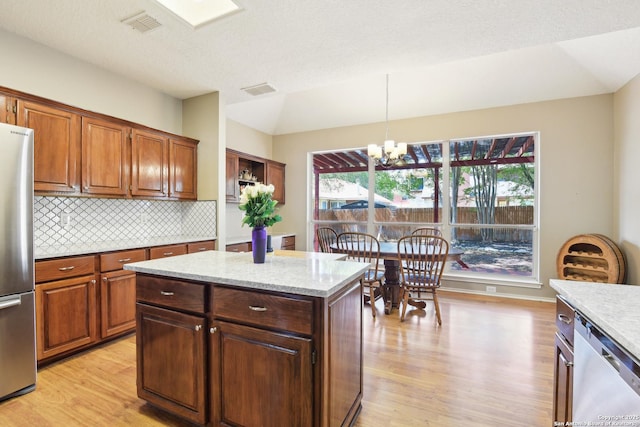 11823 Stanton, San Antonio, TX 78253 - kitchen with appliances with stainless steel finishes, light wood-type flooring, a chandelier, healthy amount of natural light, and lofted ceiling