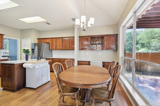 11823 Stanton, San Antonio, TX 78253 - dining room featuring light wood-style floors, a chandelier, healthy amount of natural light, and lofted ceiling
