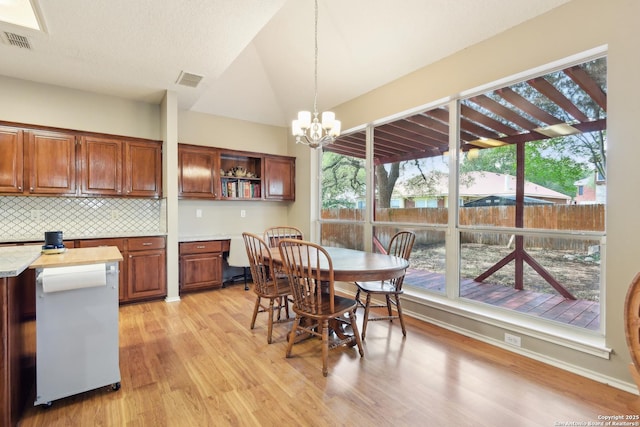 11823 Stanton, San Antonio, TX 78253 - dining space with light wood-style flooring, a chandelier, and lofted ceiling