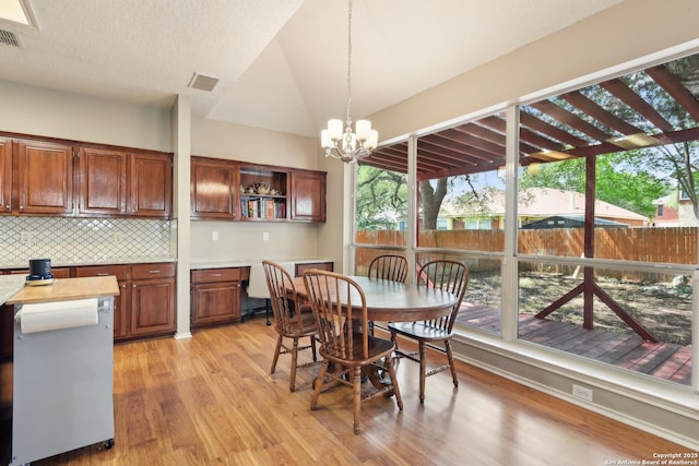 11823 Stanton, San Antonio, TX 78253 - dining area with light wood finished floors, a chandelier, and vaulted ceiling