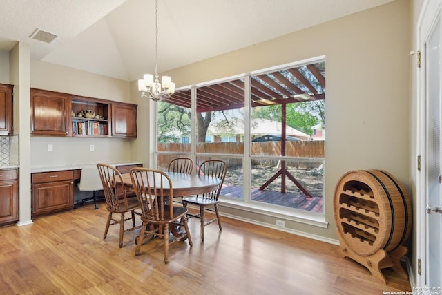 11823 Stanton, San Antonio, TX 78253 - dining area featuring light wood-type flooring, a chandelier, and lofted ceiling