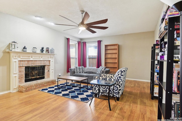 11823 Stanton, San Antonio, TX 78253 - living area featuring a ceiling fan, wood finished floors, a fireplace, and baseboards